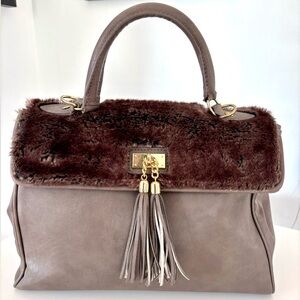 Taupe Aldo satchel bag with brown faux fur. Gold trims with tassels.
